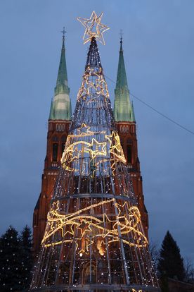 Oświetlona choinka na tle bazyliki