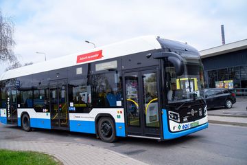 Na zdjęciu widać autobus w ruchu na drodze. 