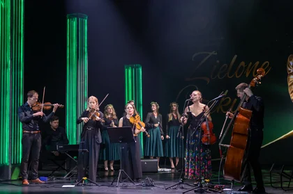 Grupa muzyków gra na scenie.