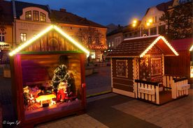 Ustawione na rynku dwa podświetlone domki, imitujące chatki z piernika. 