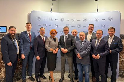 Grupa ludzi pozujących do zdjęcia.